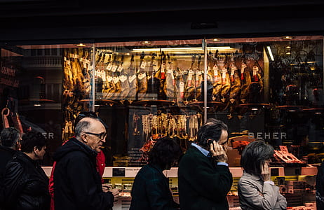 group of people walking in front of store's facade thumbnail