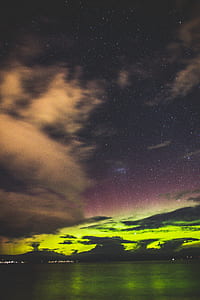 body of water under white clouds at nighttime thumbnail