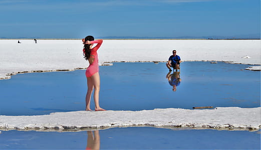 Woman in Pink Long-sleeved Swimsuit on Island thumbnail