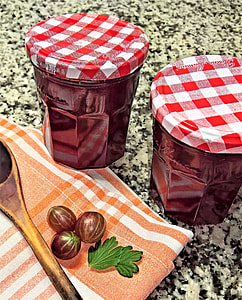 two red metal jars beside of serving spoon thumbnail