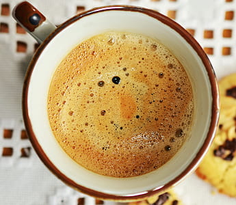 brown liquid on white and brown ceramic mug macro photography thumbnail