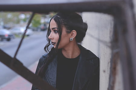 woman in black leather top looking sideways thumbnail