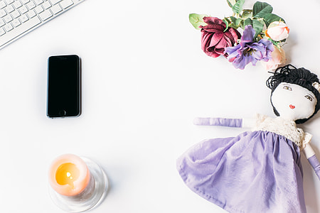 Styled photo with doll and iPhone thumbnail