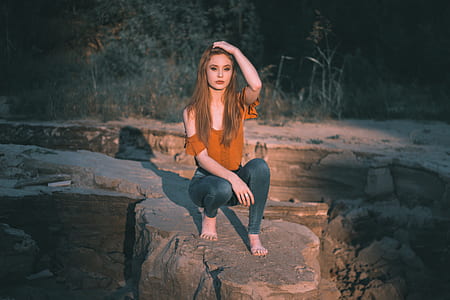 woman sitting on boulder outdoor during daytime thumbnail