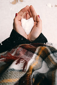 Hand holding White Snow in Heart shape thumbnail