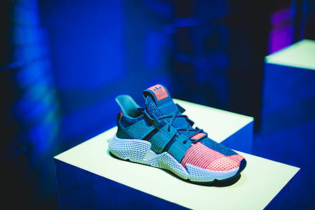 unpaired blue and red adidas running shoe on board thumbnail