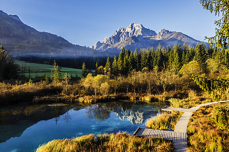 body of water surrounded by trees near mountain thumbnail