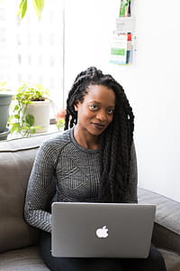 Woman Wearing Gray Sweater With Silver Macbook on Her Lap thumbnail