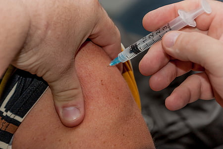 person holding syringe while injected to skin thumbnail