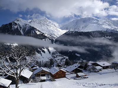 houses near mountain under blue sky thumbnail