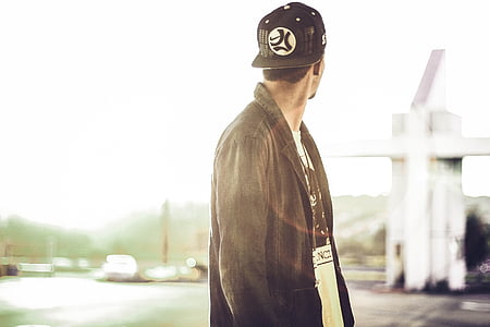 man wearing black coat and cap thumbnail