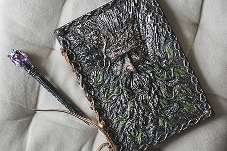 gray and green steel frame with ballpoint pen above white cushion surface thumbnail