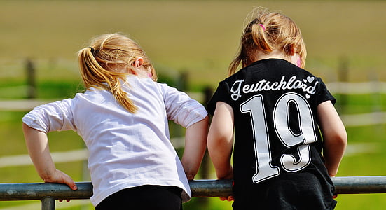two girls wearing white and black shirts thumbnail