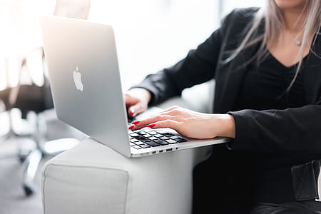 Business Woman Using Her Laptop on a Sofa thumbnail