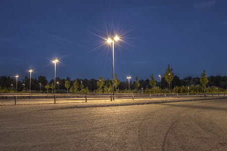 Photography of Empty Field With Post Lamps thumbnail