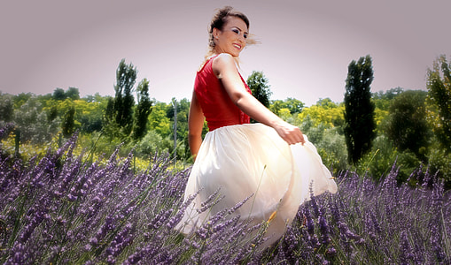 woman in red and white sleeveless dress standing in lavender field thumbnail