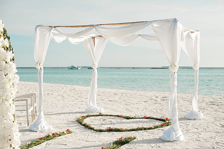 White Fabric Canopy Tent With Green Heart Floor Decor at Beach thumbnail