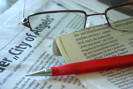 pen on journal beside eyeglasses thumbnail