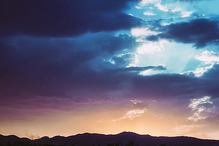 mountain under cloudy sky during daytime thumbnail