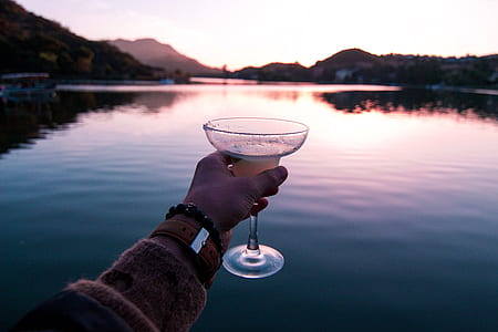 person holding martini glass thumbnail