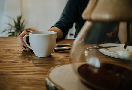 person in front of white ceramic cup thumbnail