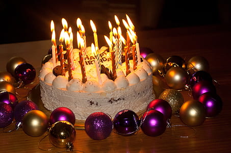baked cake with candles and christmas baubles thumbnail