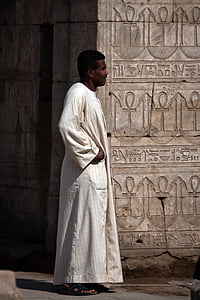 man standing near wall at daytime thumbnail