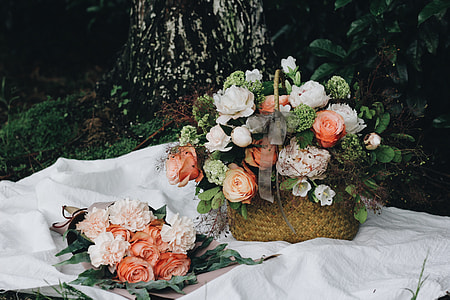 white, orange, and pink flower on wicker basket thumbnail