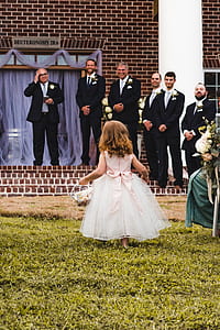 flower girl in front of groomsmen at daytime thumbnail