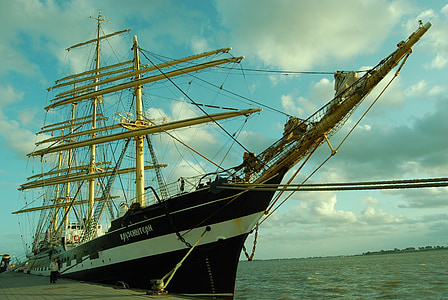 black cruise ship beside boat dock thumbnail