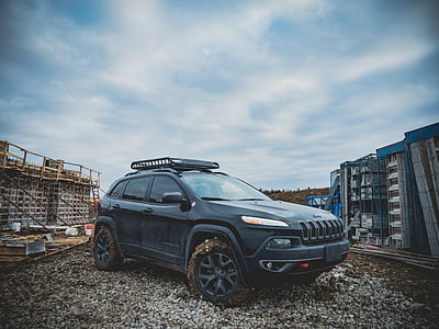 black Jeep Compass SUV on dirt road thumbnail