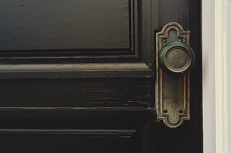 black wooden door with black metal door knob thumbnail