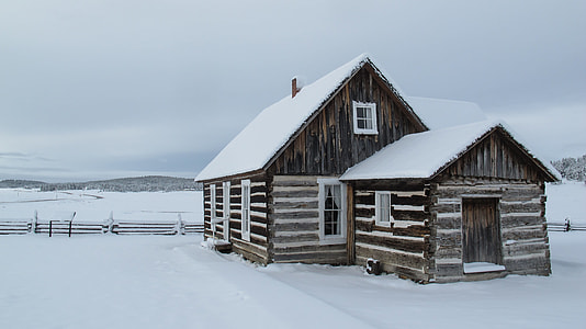 brown and white wooden house with snow at daytime thumbnail