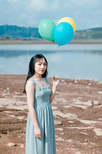 Photography of a Woman Holding Balloons thumbnail