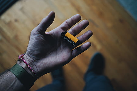person holding yellow Kodak film thumbnail