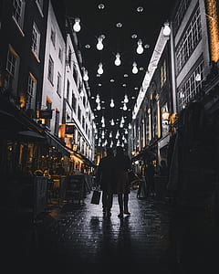 two person walking in the middle of the building thumbnail
