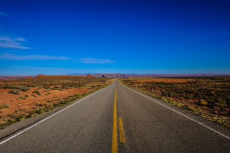 Straight Road Surrounded With Grass thumbnail