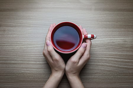 Woman holding hot cup of tea thumbnail