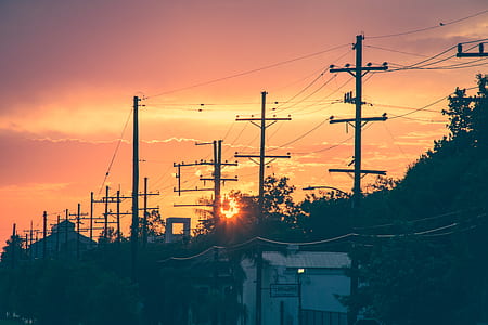 electric posts near white concrete house thumbnail
