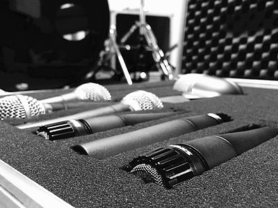 grayscale photo of assorted microphones of case thumbnail