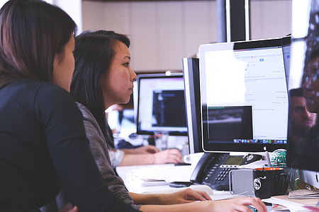 two women using computer during daytime thumbnail