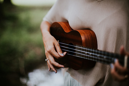 focus photo of person playing Ukulele thumbnail
