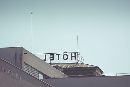 black metal HOTEL signage above high rise building thumbnail