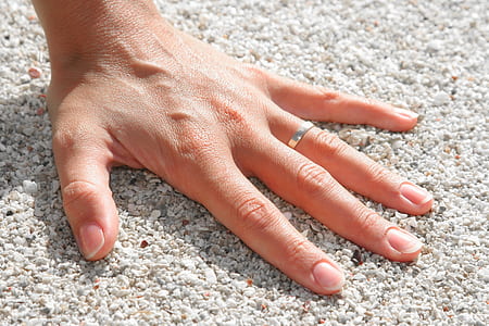 Lef Humand Hand Wearing Silver Ring on the Soil thumbnail