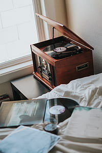 brown and black vinyl player beside window thumbnail
