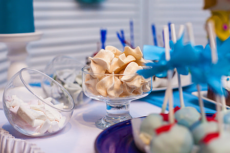clear glass candy dishes and cake pops on white table thumbnail