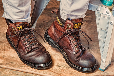 person in brown pants with brown Caterpillar leather work boots thumbnail