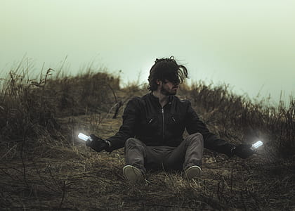 man sitting on ground holding bulb thumbnail