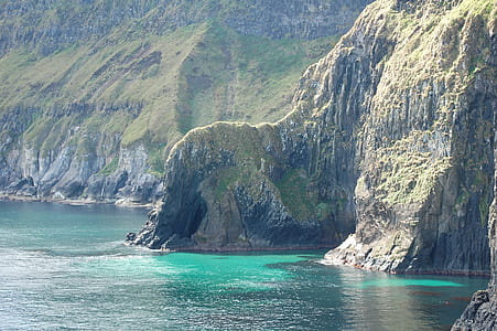 mountain near water during daytime thumbnail