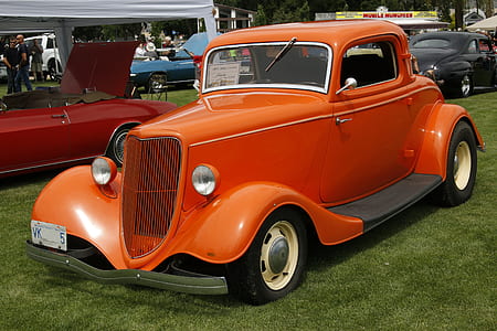 Orange Classic Coupe on Green Grass Field thumbnail